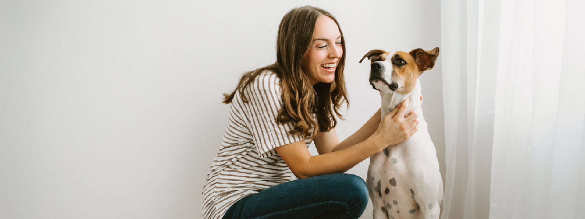 Happy woman with her dog at home